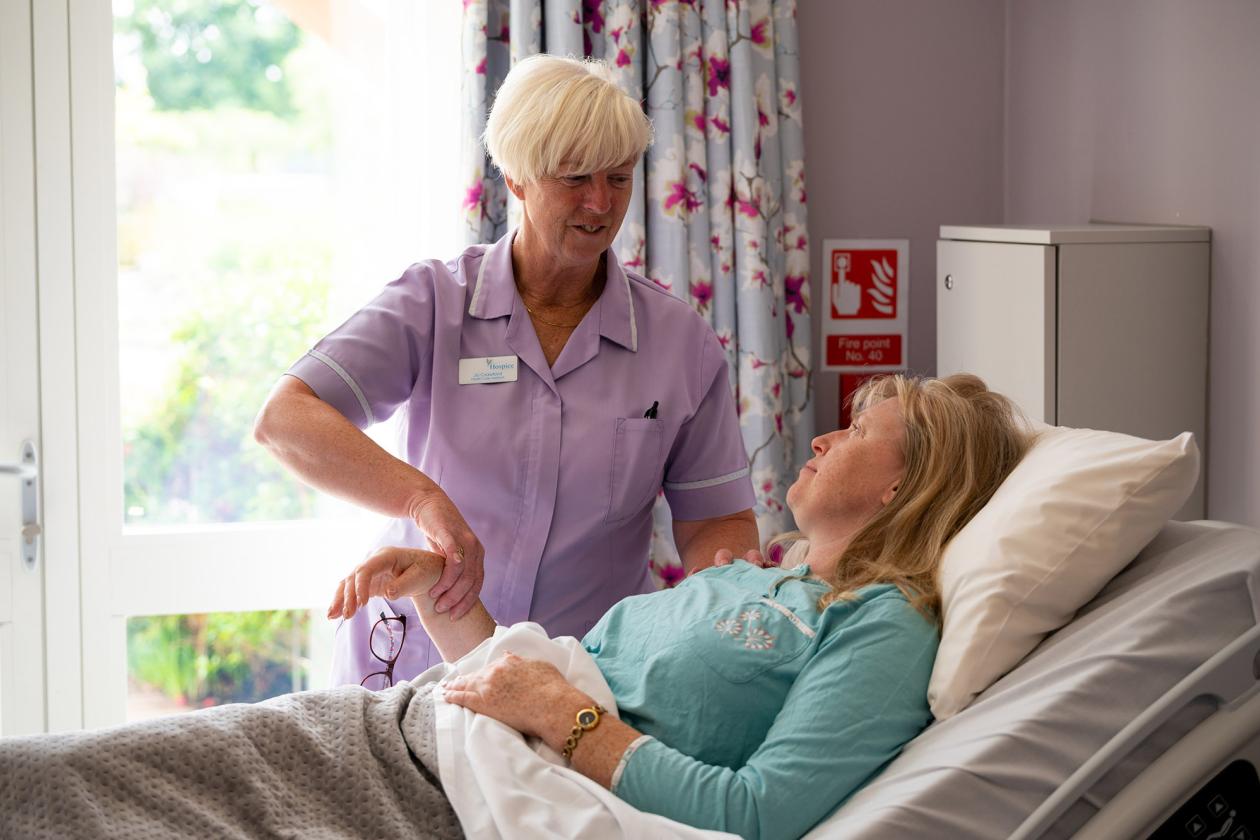 A patient having pulse checked in bed