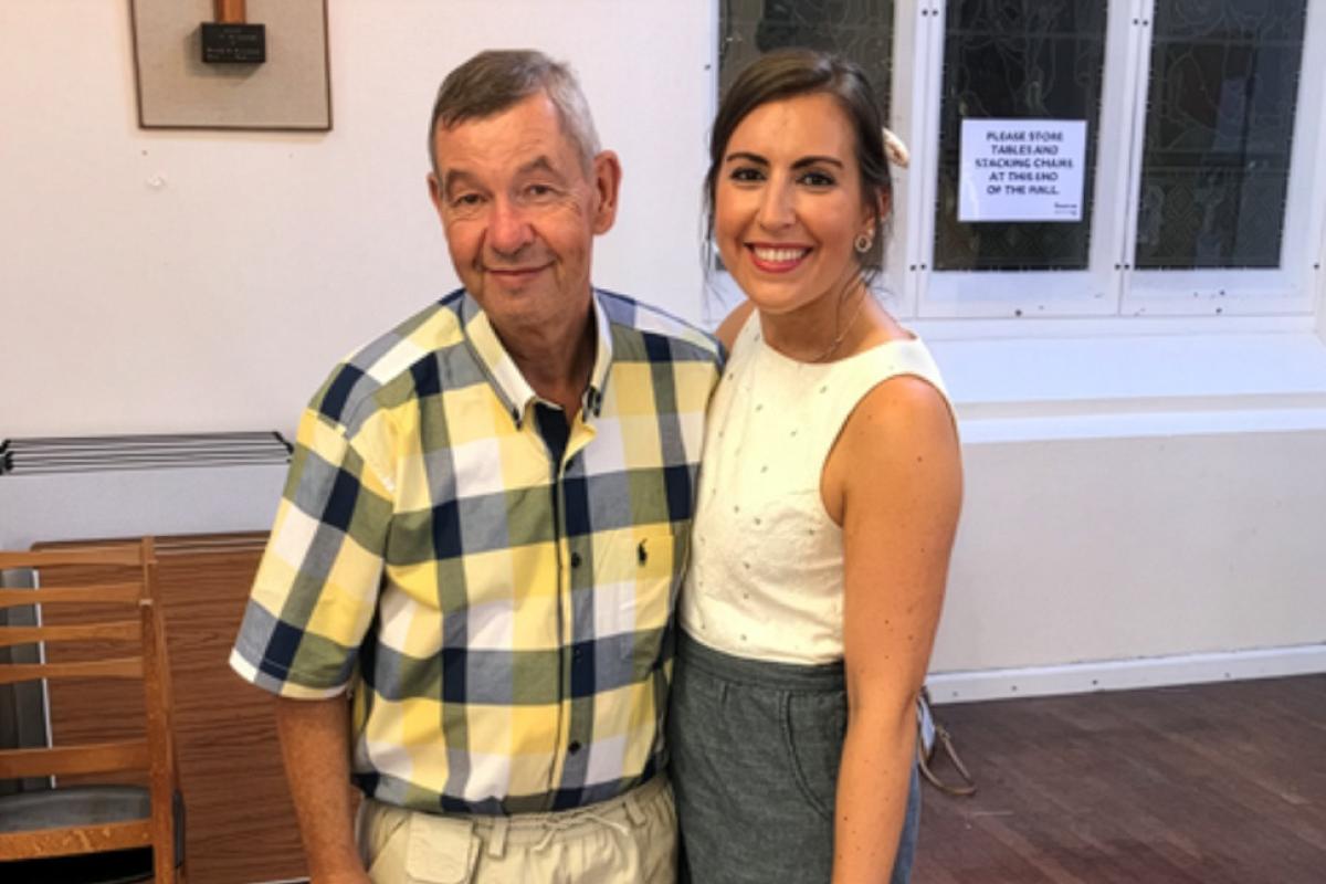 A young lady stood next to her Dad