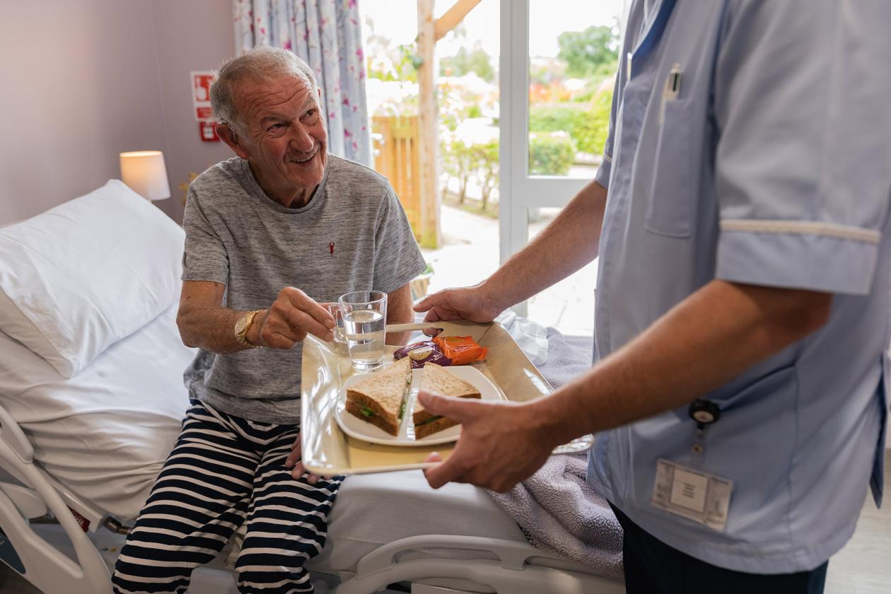 Patient receiving a meal from a nurse