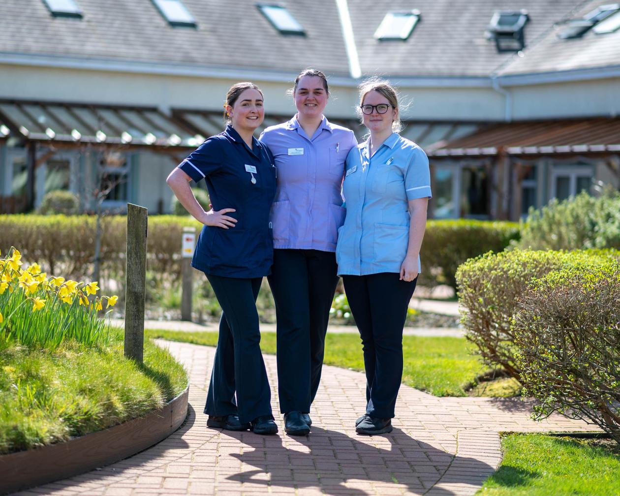 Three Hospice staff members in Hospice Gardens