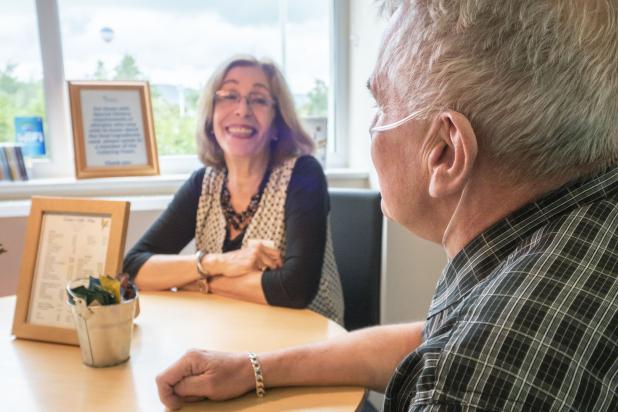 Hospice patient enjoying a chat with a volunteer