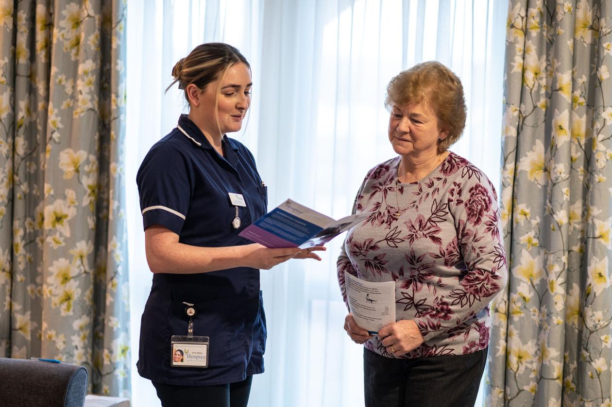 Hospice nurse explaining Hospice services to member of the public