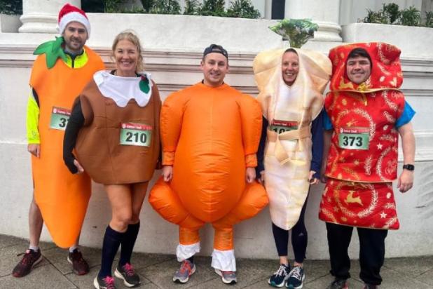 Five runners in fancy dress preparing to run in charity event
